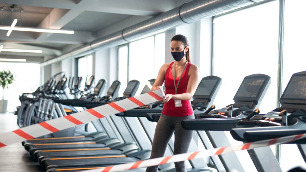 woman with face mask marking safe distance in gym 2024 10 18 17 45 37 utc